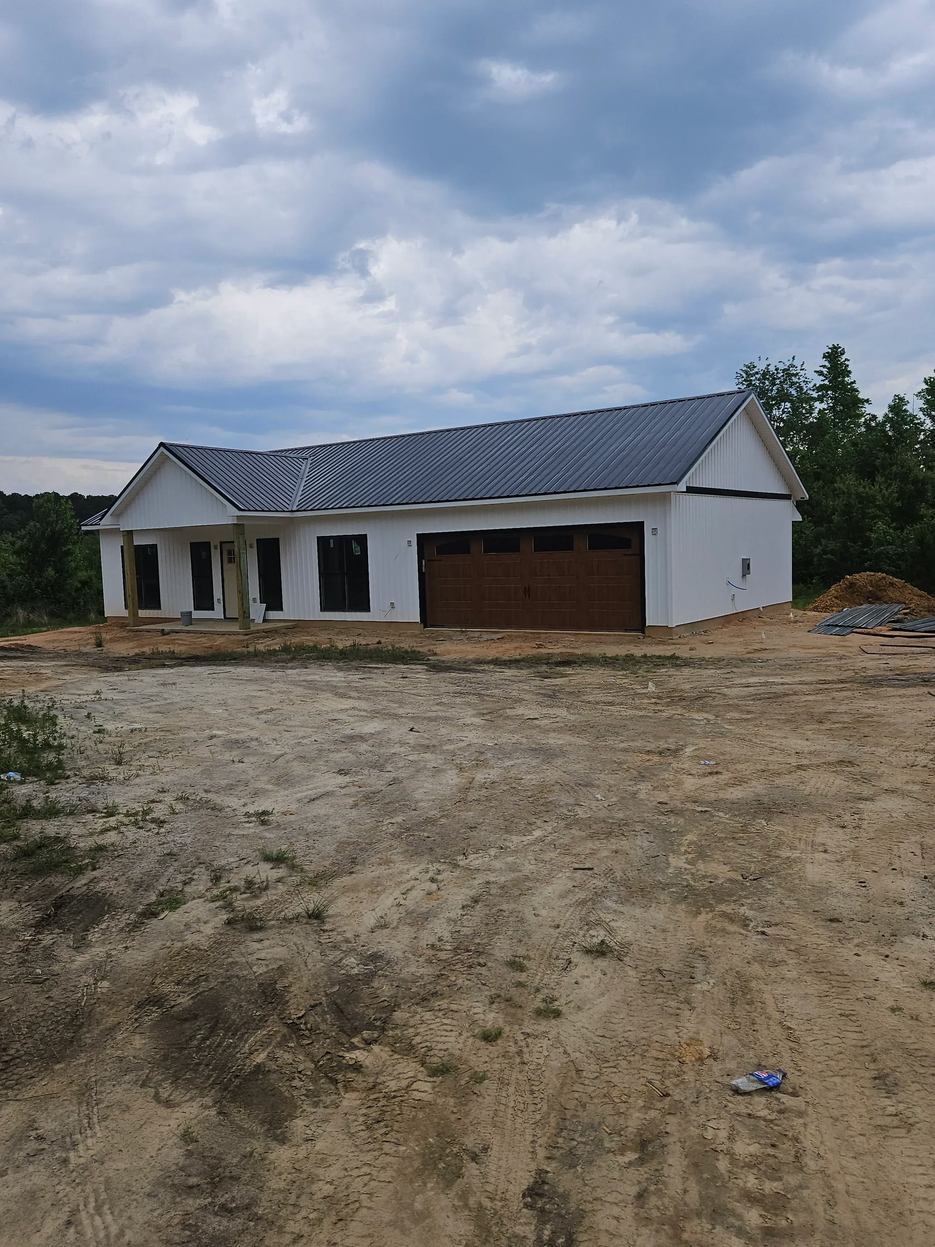 White fiber cement siding with standing seam metal roof on modern residential home