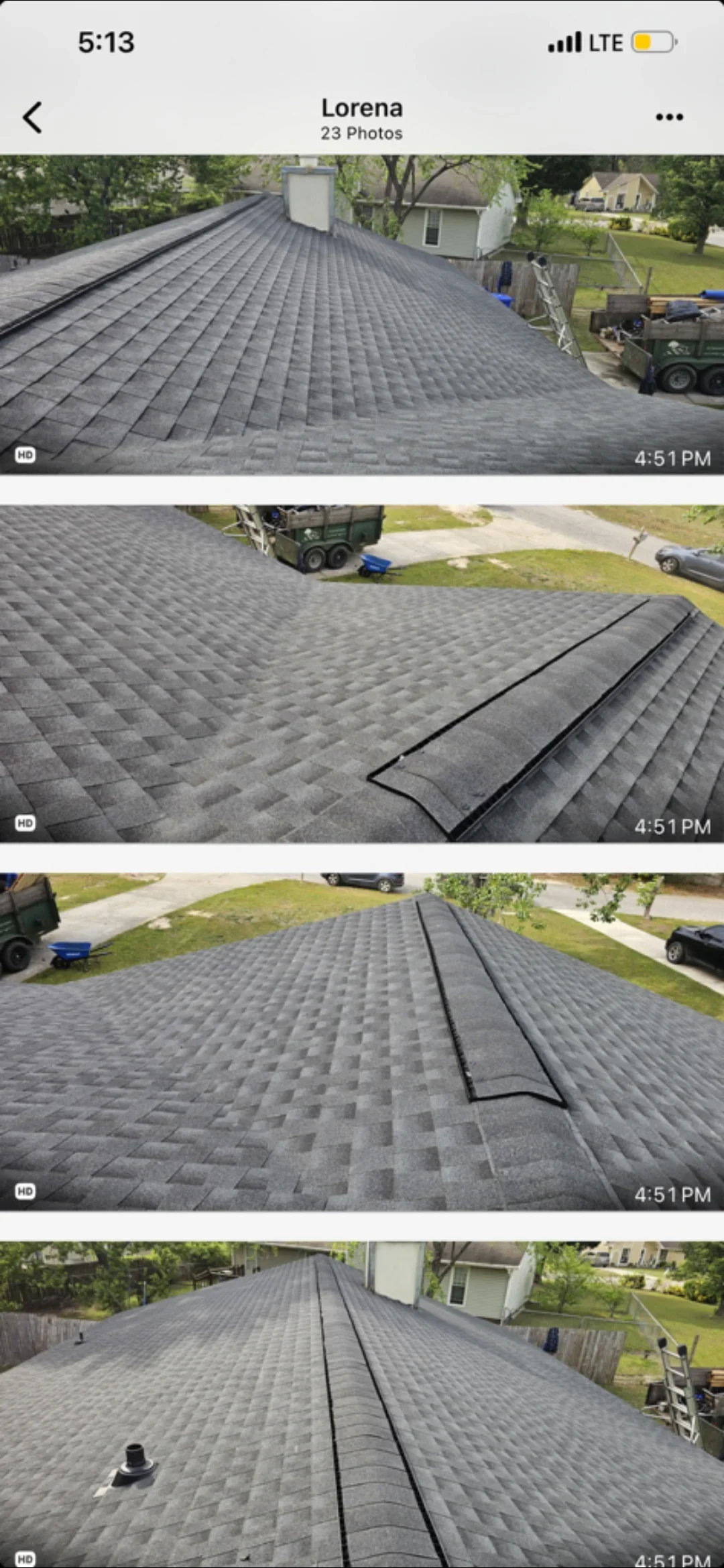 Charcoal gray architectural shingles installed on residential roof with ridge flashing and multiple roof planes