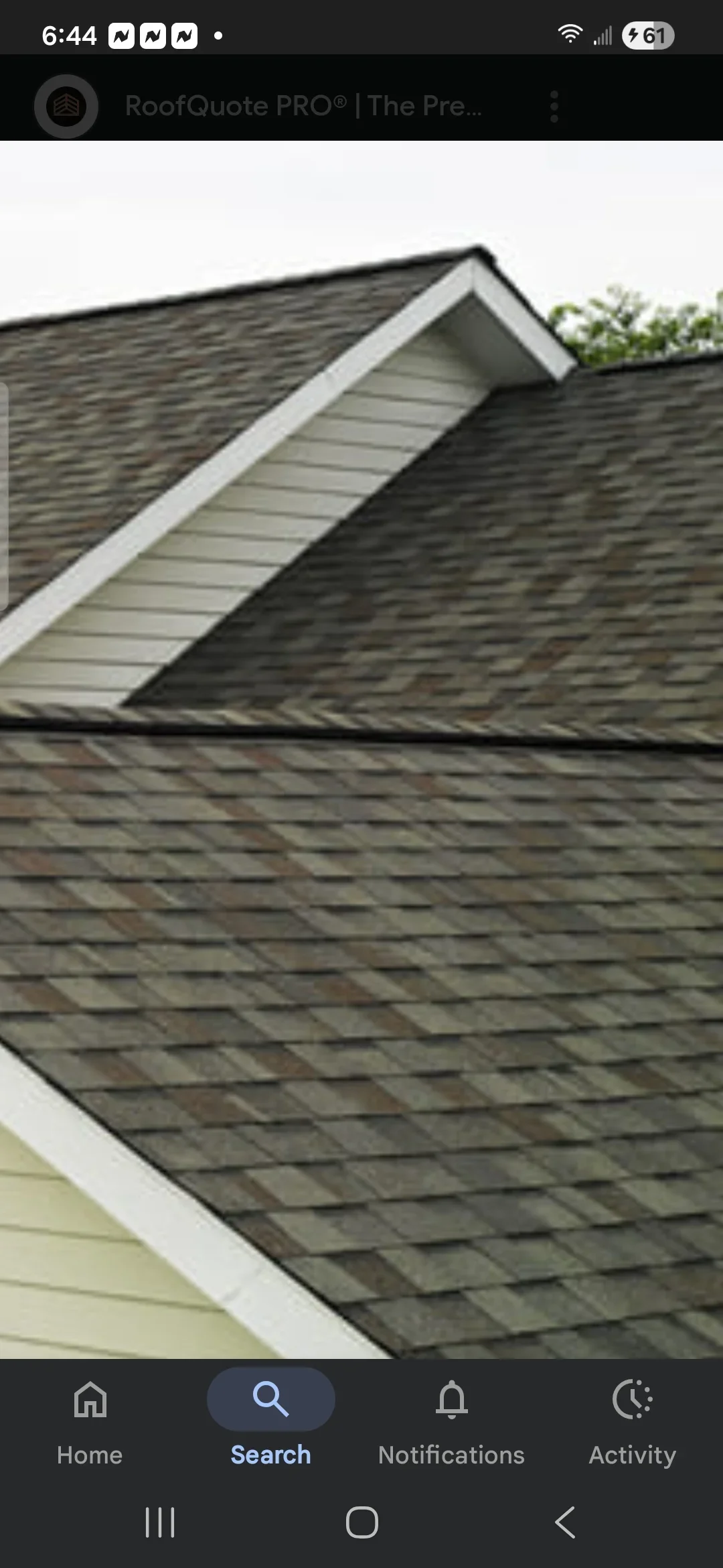 Charcoal gray architectural shingle roof with white fascia trim and roof penetration flashing