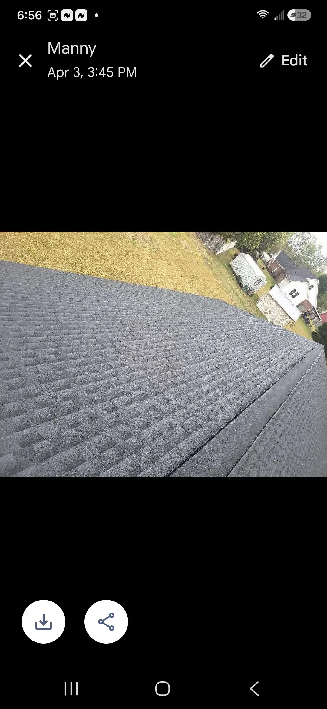 Newly installed charcoal gray dimensional asphalt shingles on residential roof with clean edges and proper alignment