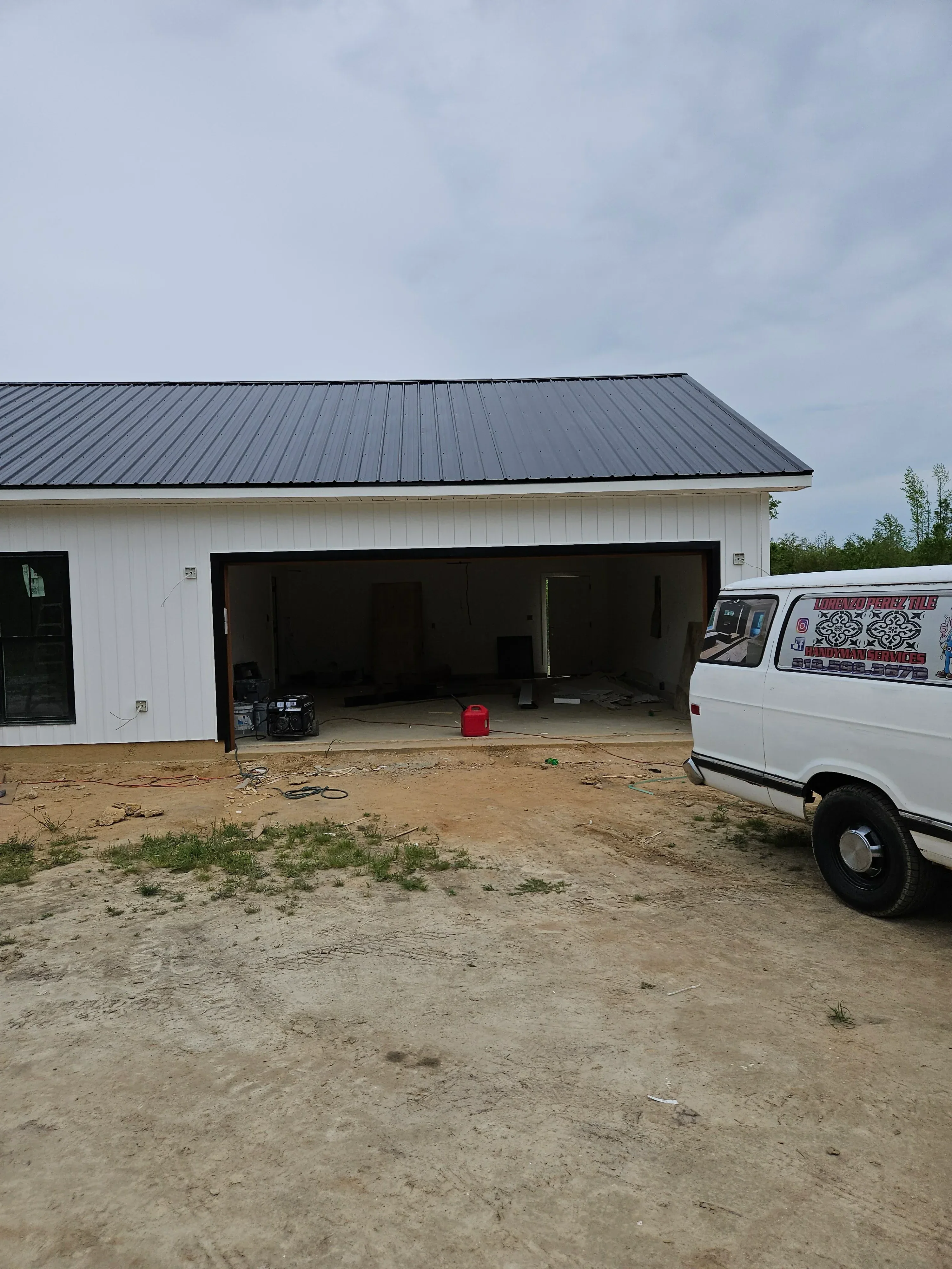 Metal standing seam roof on white food service trailer with vent and lighting fixtures