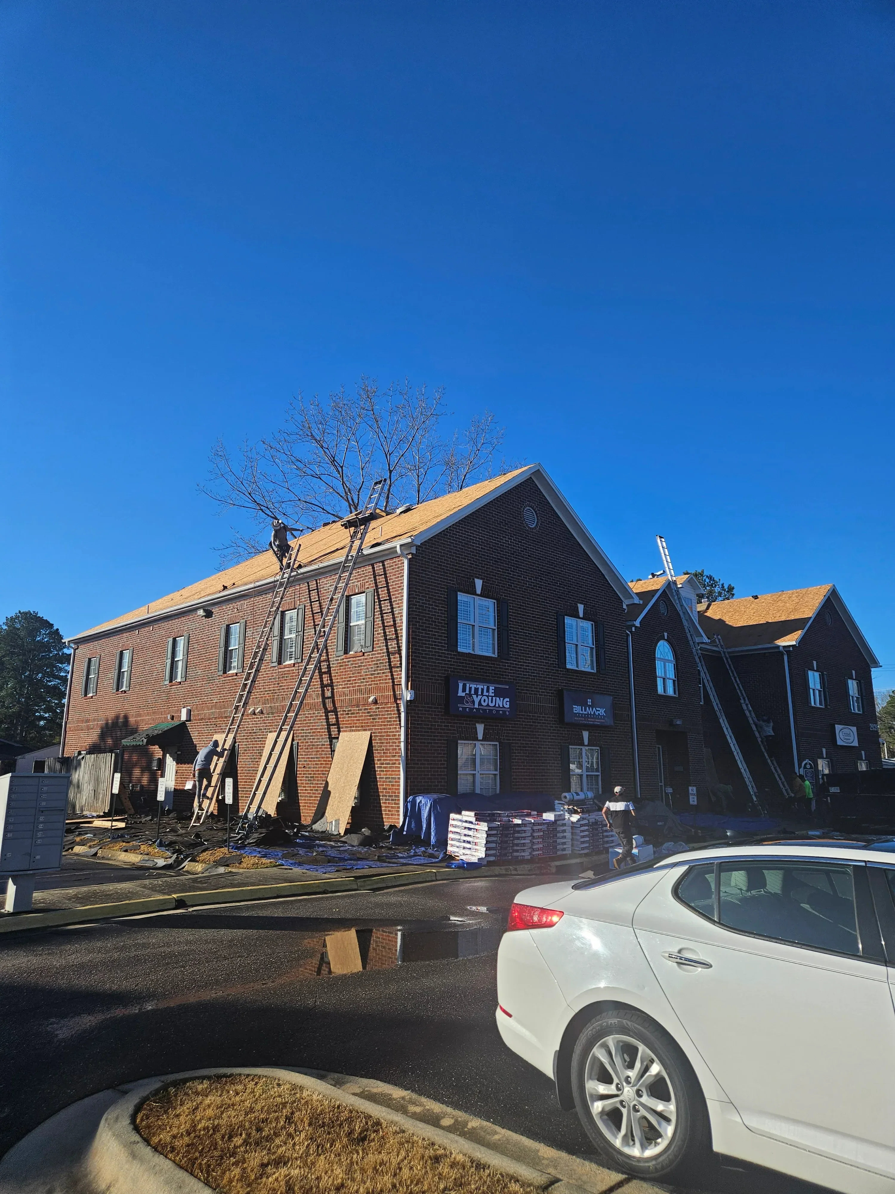 Commercial building with new corrugated metal roof and blue solar panels installed