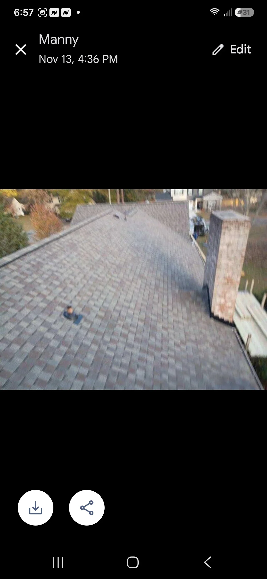 Gray architectural shingles installed on residential roof with brick chimney and proper alignment