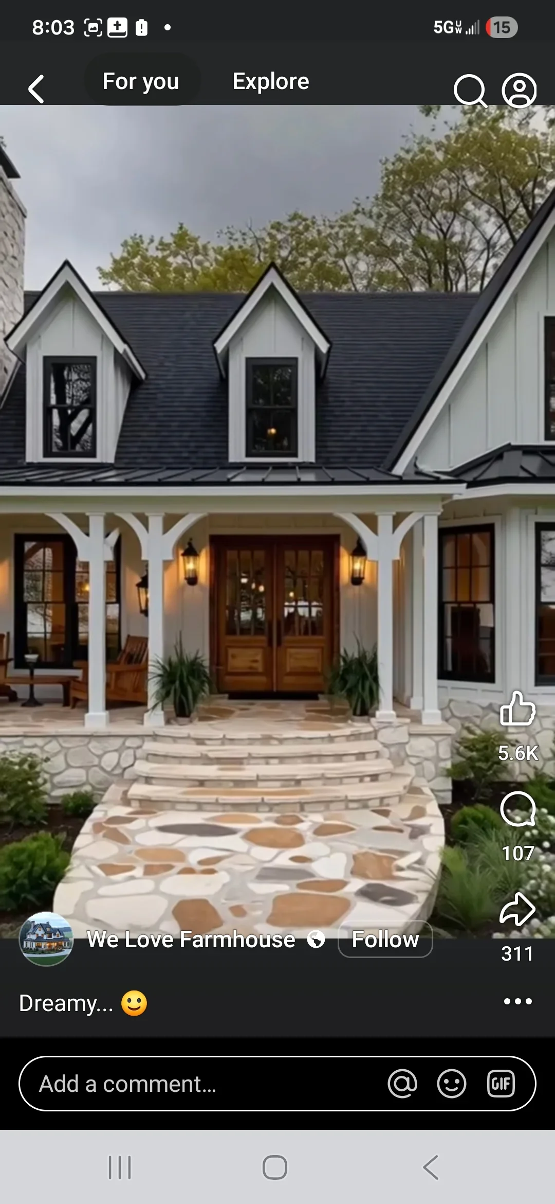 Dark architectural shingle roof with gabled dormers on white farmhouse exterior