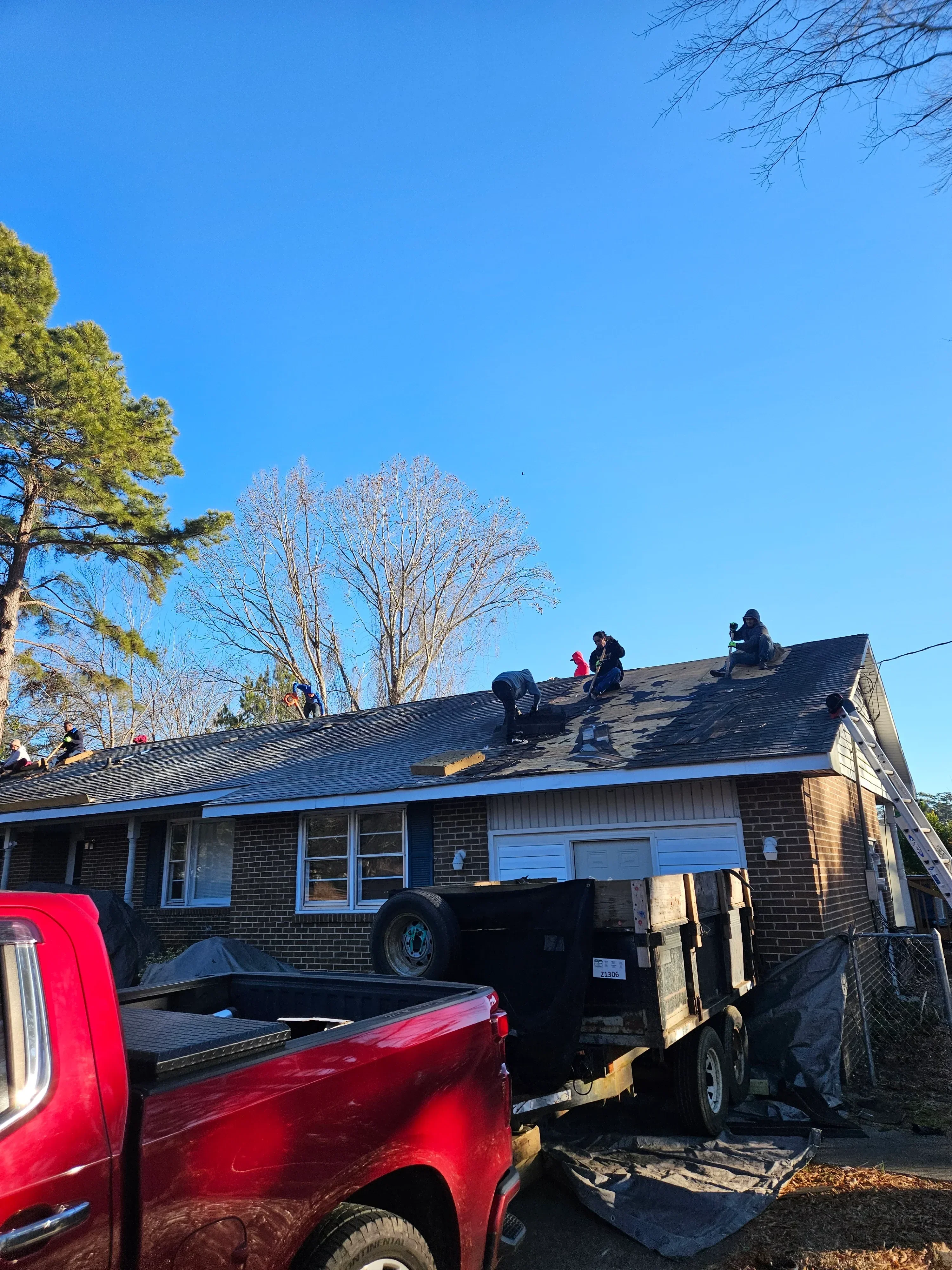 New asphalt shingle roof installation on residential home with updated flashing and ventilation